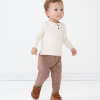 Child wearing Light Cocoa joggers and coordinating Cream henley tee