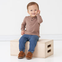 Alternate image of a child sitting on a box wearing a Light Cocoa henley tee