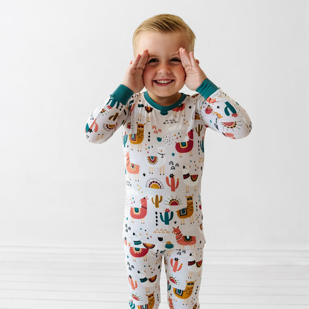 Close up image of a child wearing a Llama Love two piece pajama set