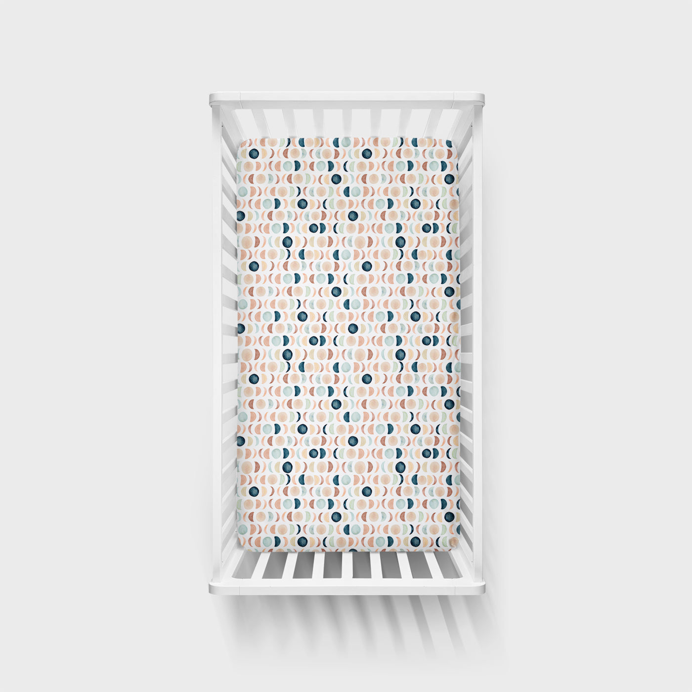 Top view image of Luna Neutral fitted crib sheet in a white crib