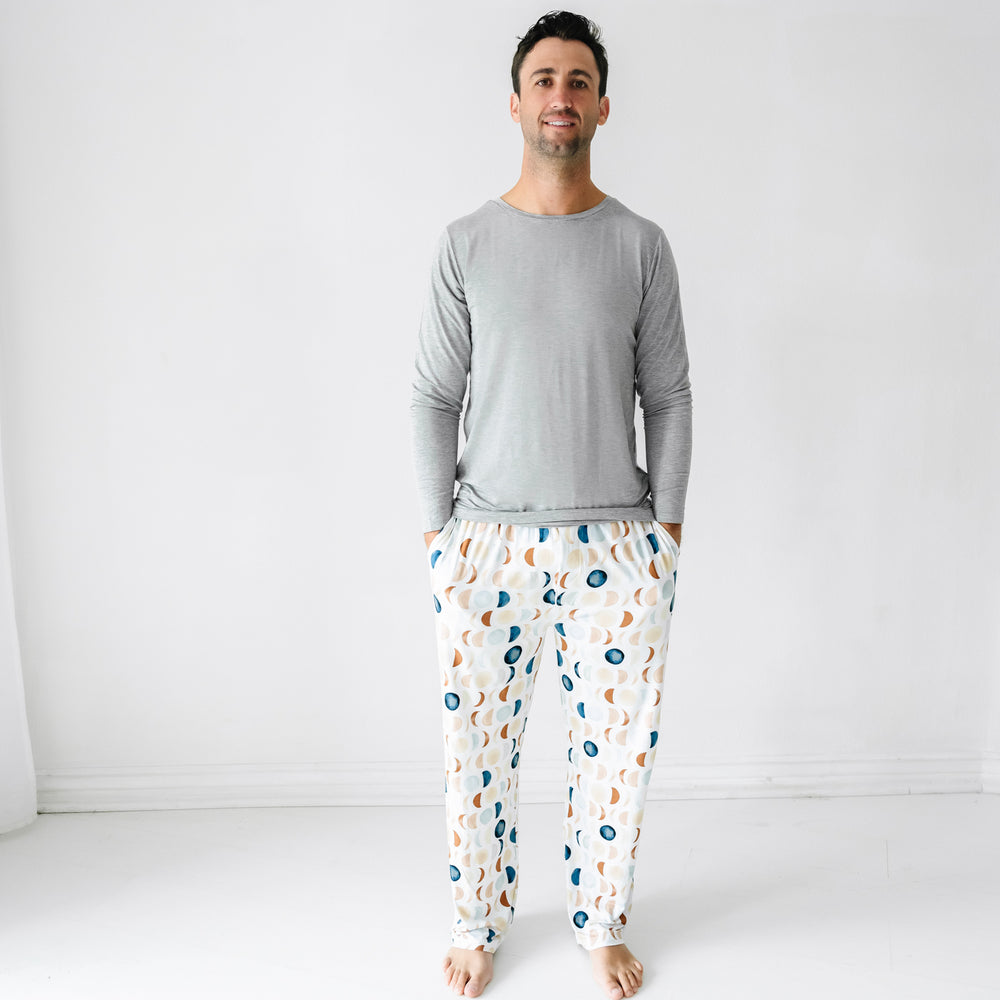Man wearing heather gray long sleeve pj top paired with men's Luna Neutral pj pants