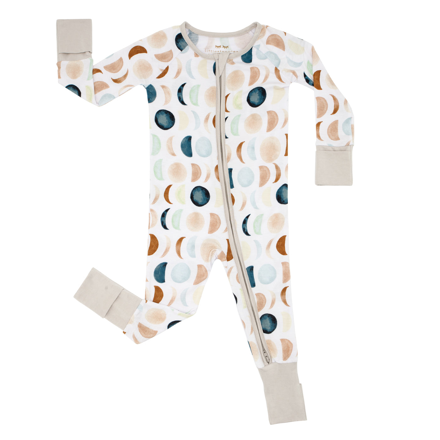 Flat lay image of a long sleeve zipper romper pajama in Luna Neutral print. This print features phases of the moon in the sweetest shades of creams, tans, and navy watercolor in an all over repeat pattern.