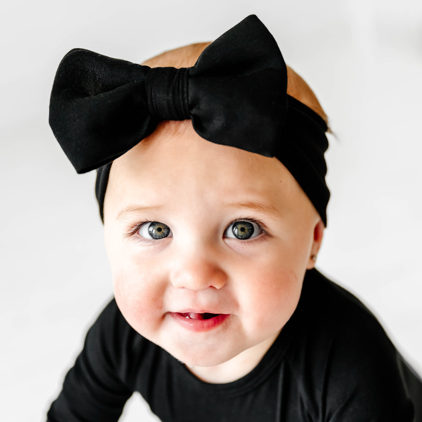 Alternative close up image of baby wearing theLuxe Bow - Black Luxe Bow Headband