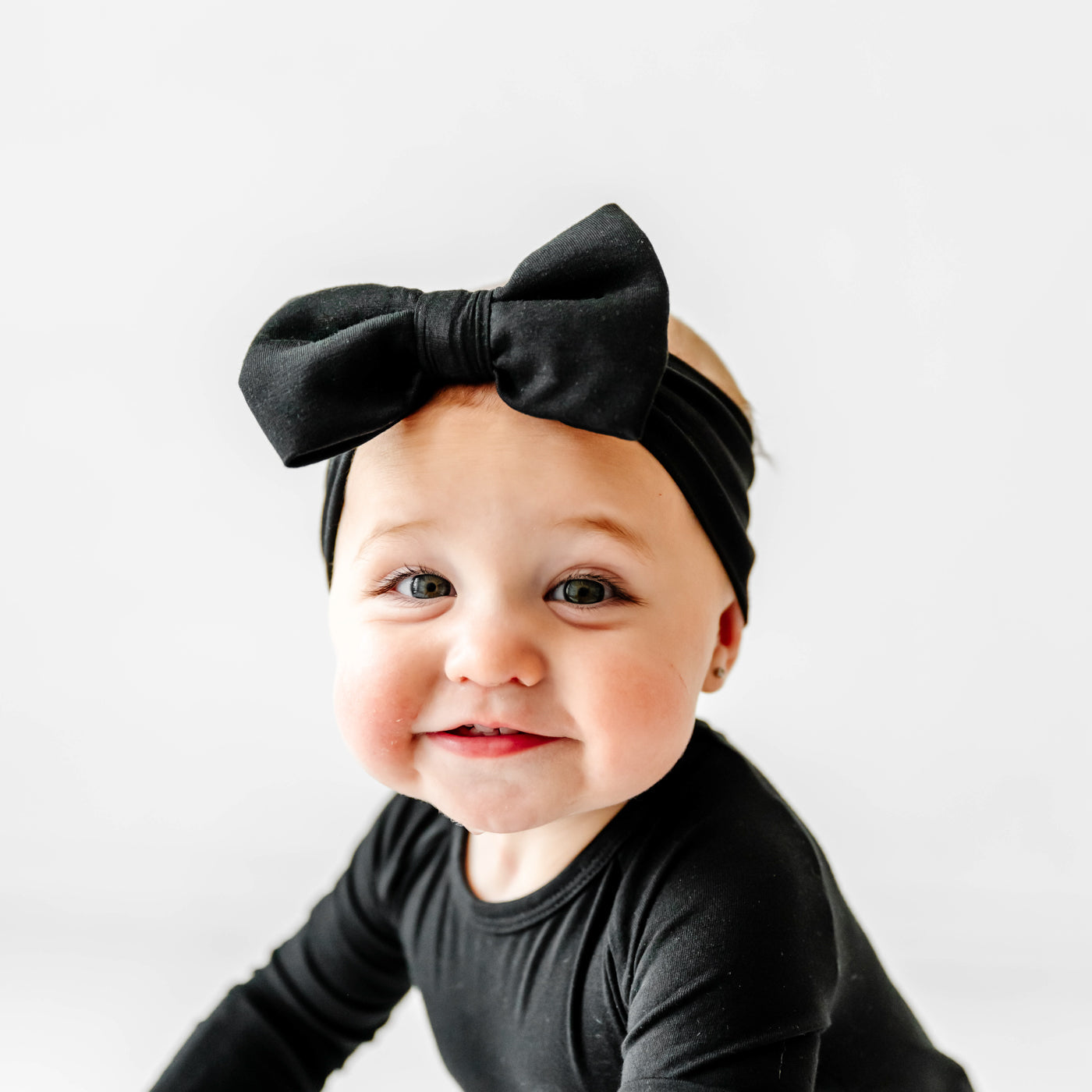 Additional close up image of baby wearing the Black Luxe Bow Headband