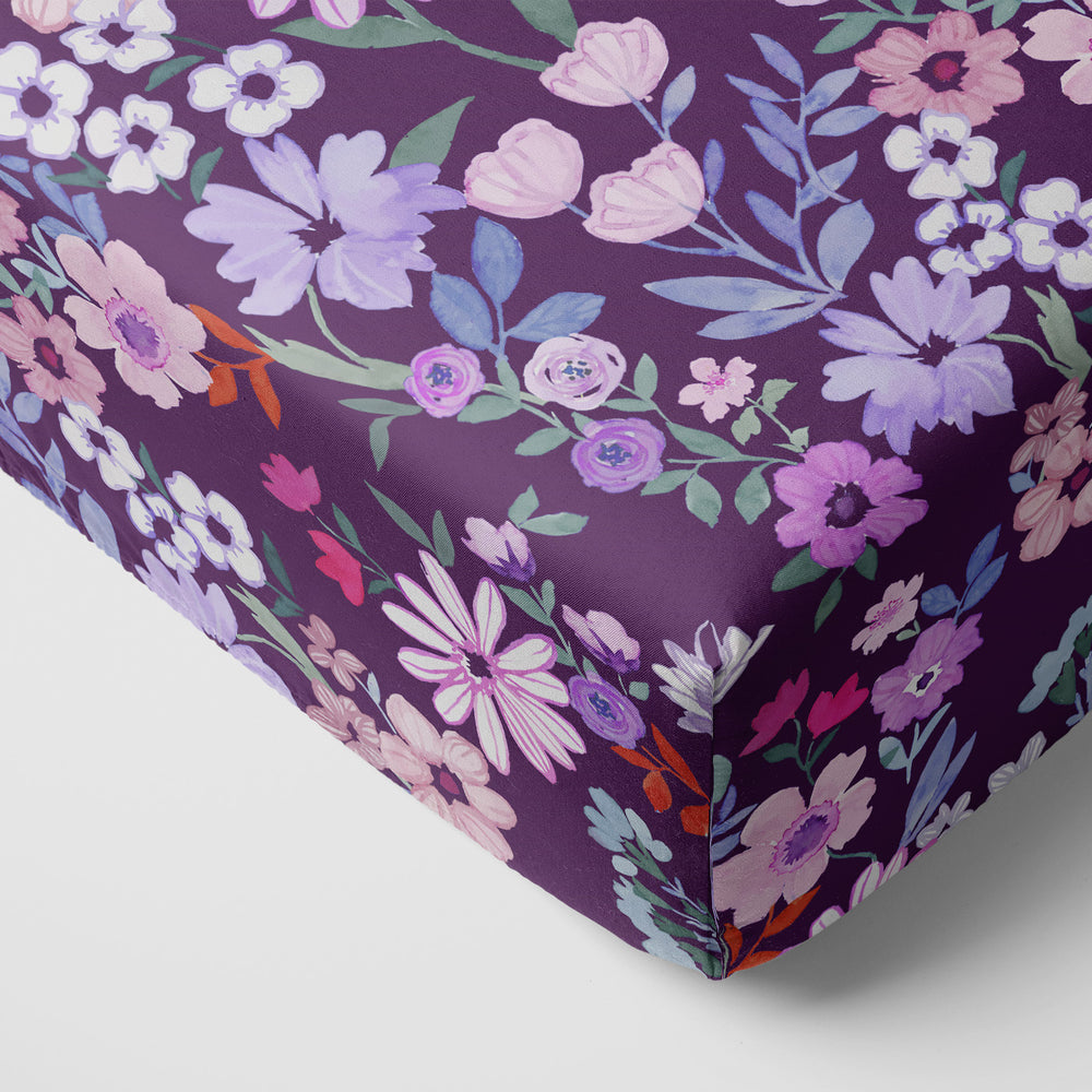 Corner view of the Violet Meadow Fitted Crib Sheet