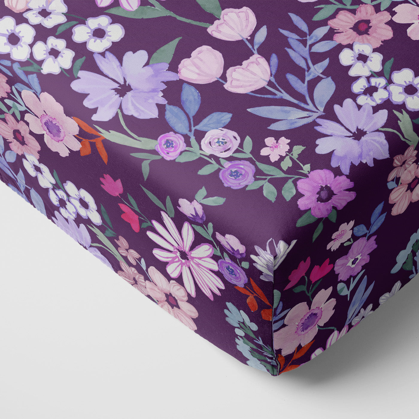 Corner view of the Violet Meadow Fitted Crib Sheet