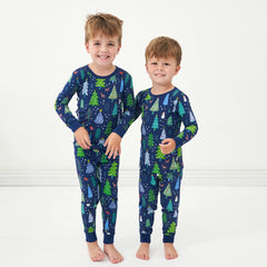 Two children wearing Blue Merry and Bright two piece pajama sets