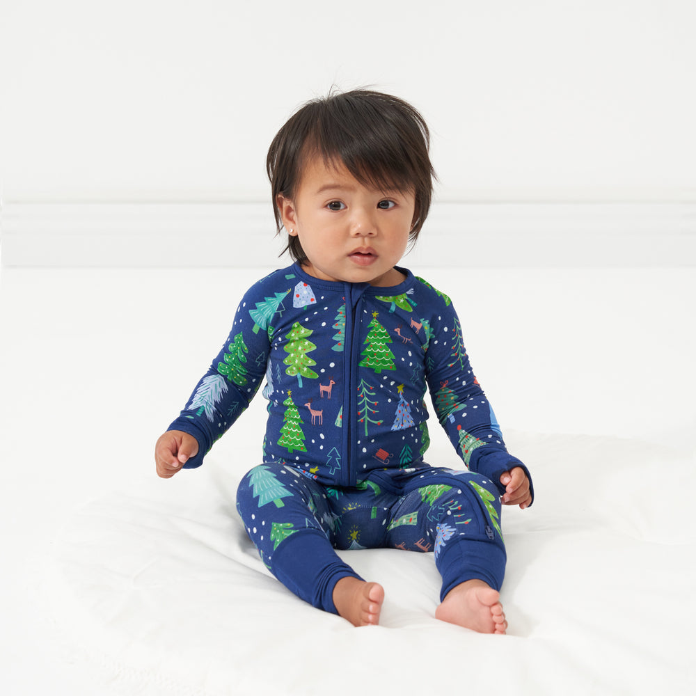 Alternate image of a child sitting on a bed wearing a Blue Merry and Bright zippy