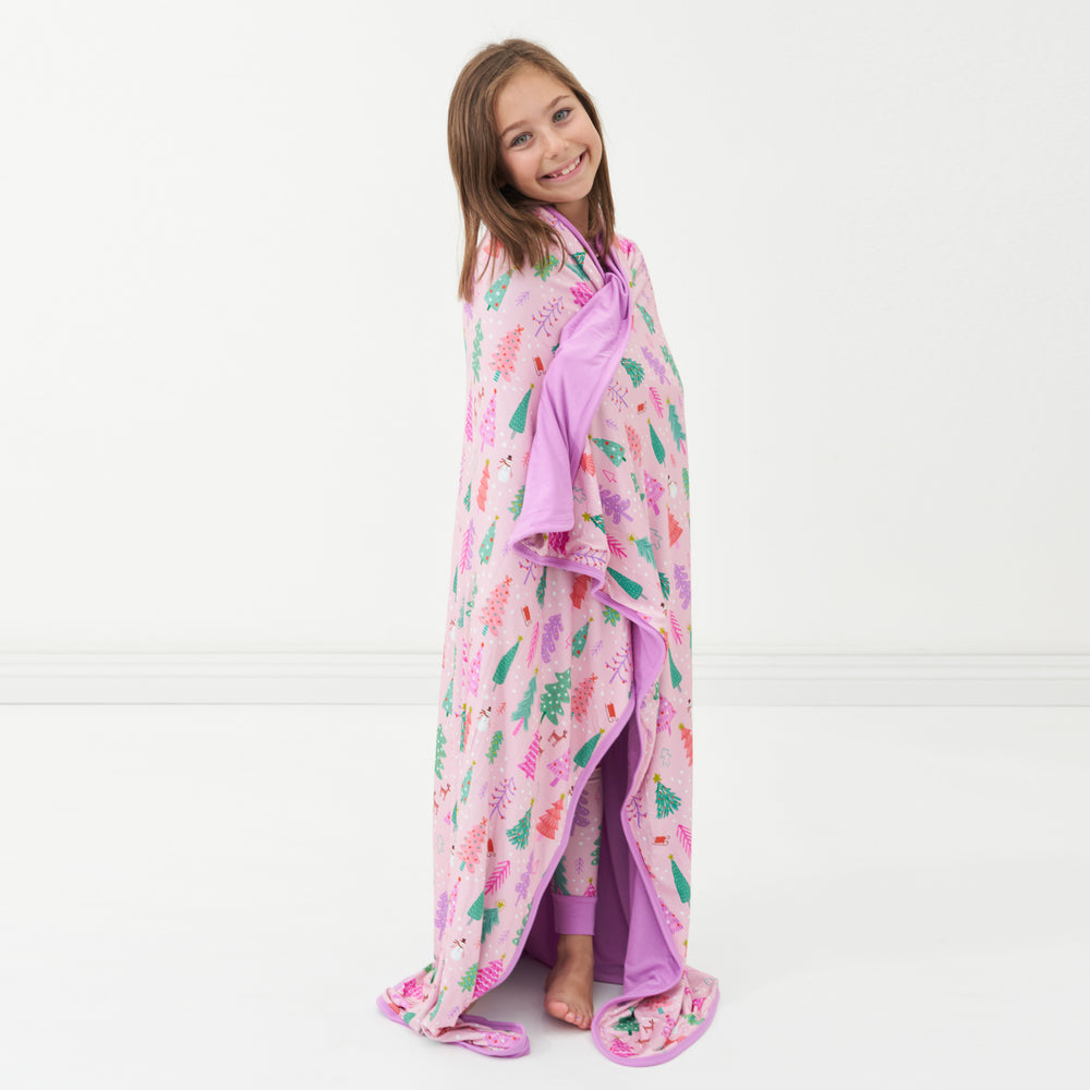Child wrapped up in a Pink Merry and Bright cloud blanket