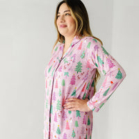 Profile view of a woman wearing a Pink Merry and Bright women's long sleeve sleep shirt