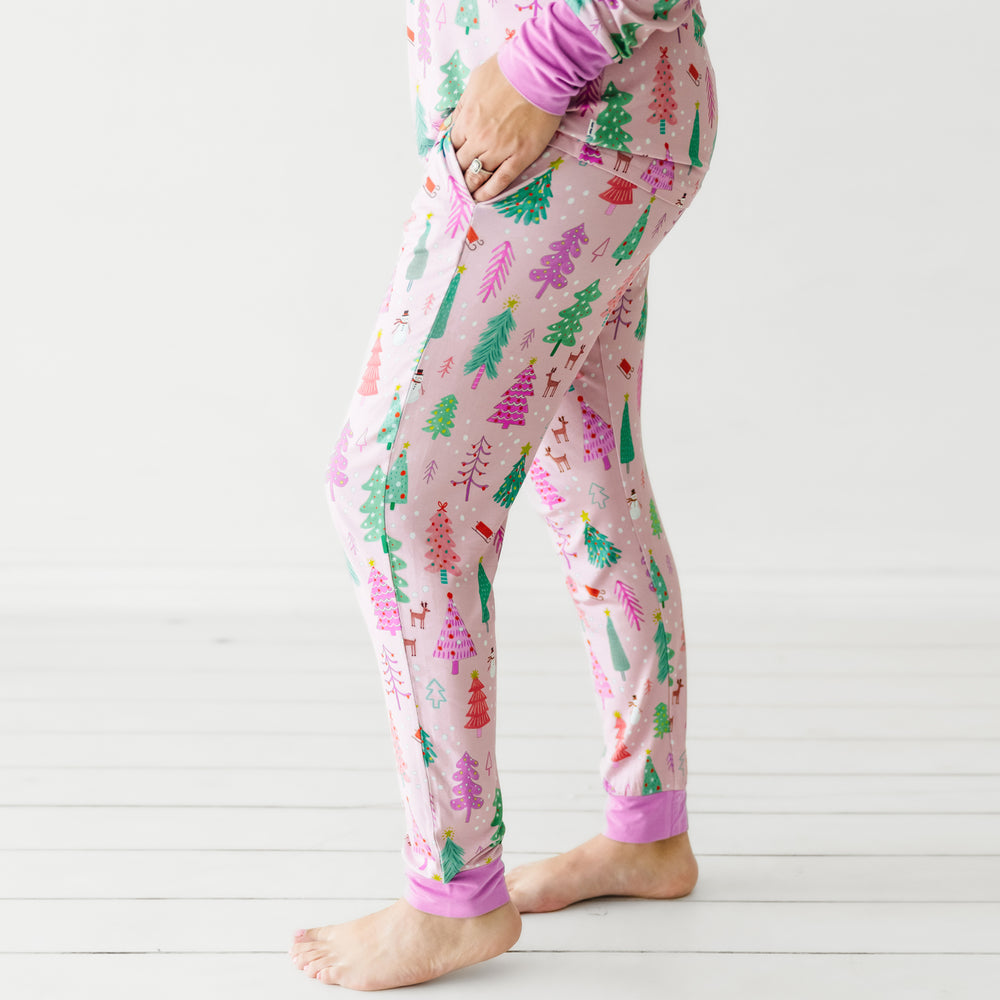 Profile view of a woman wearing Pink Merry and Bright women's pajama pants