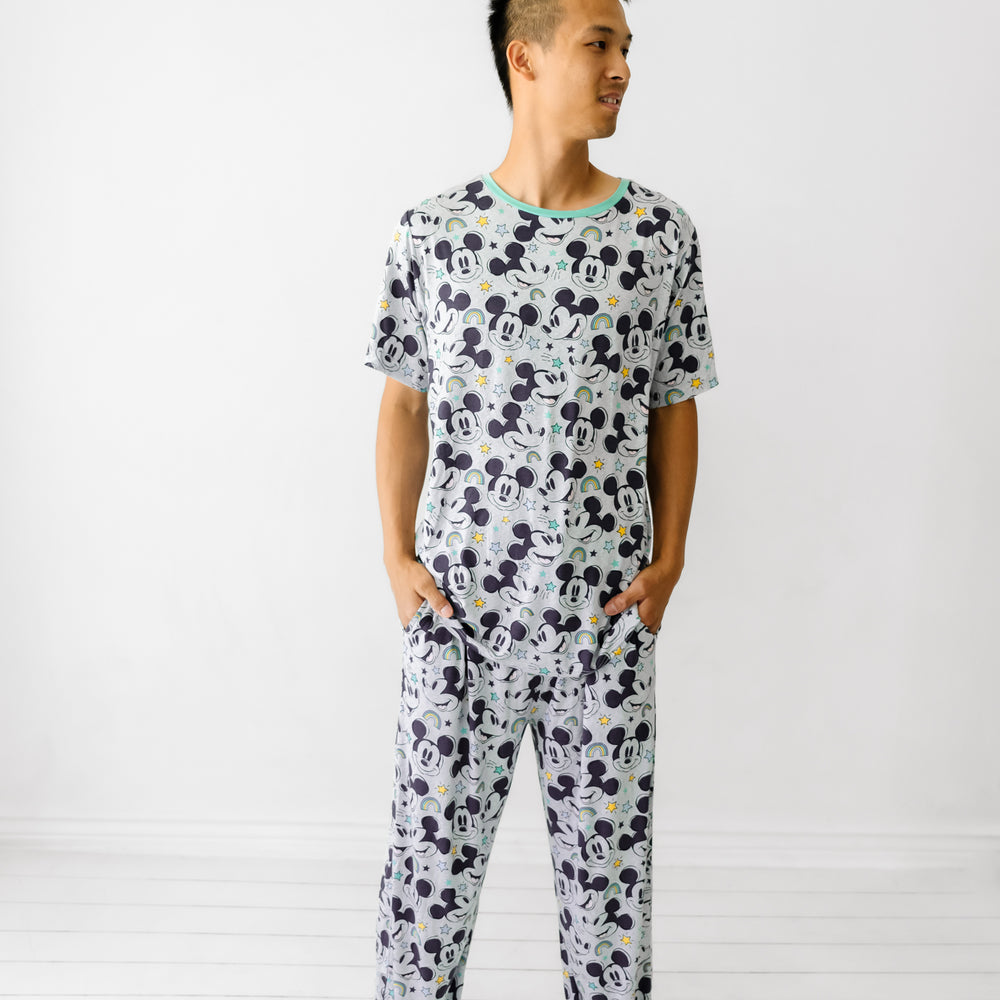 Man wearing Mickey Forever printed men's pajama pants and matching pajama top
