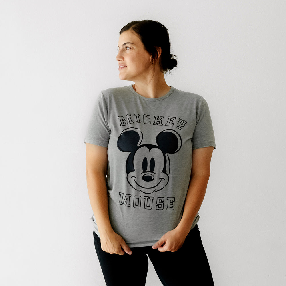 Woman looking off to the side wearing a Mickey collegiate women's graphic tee