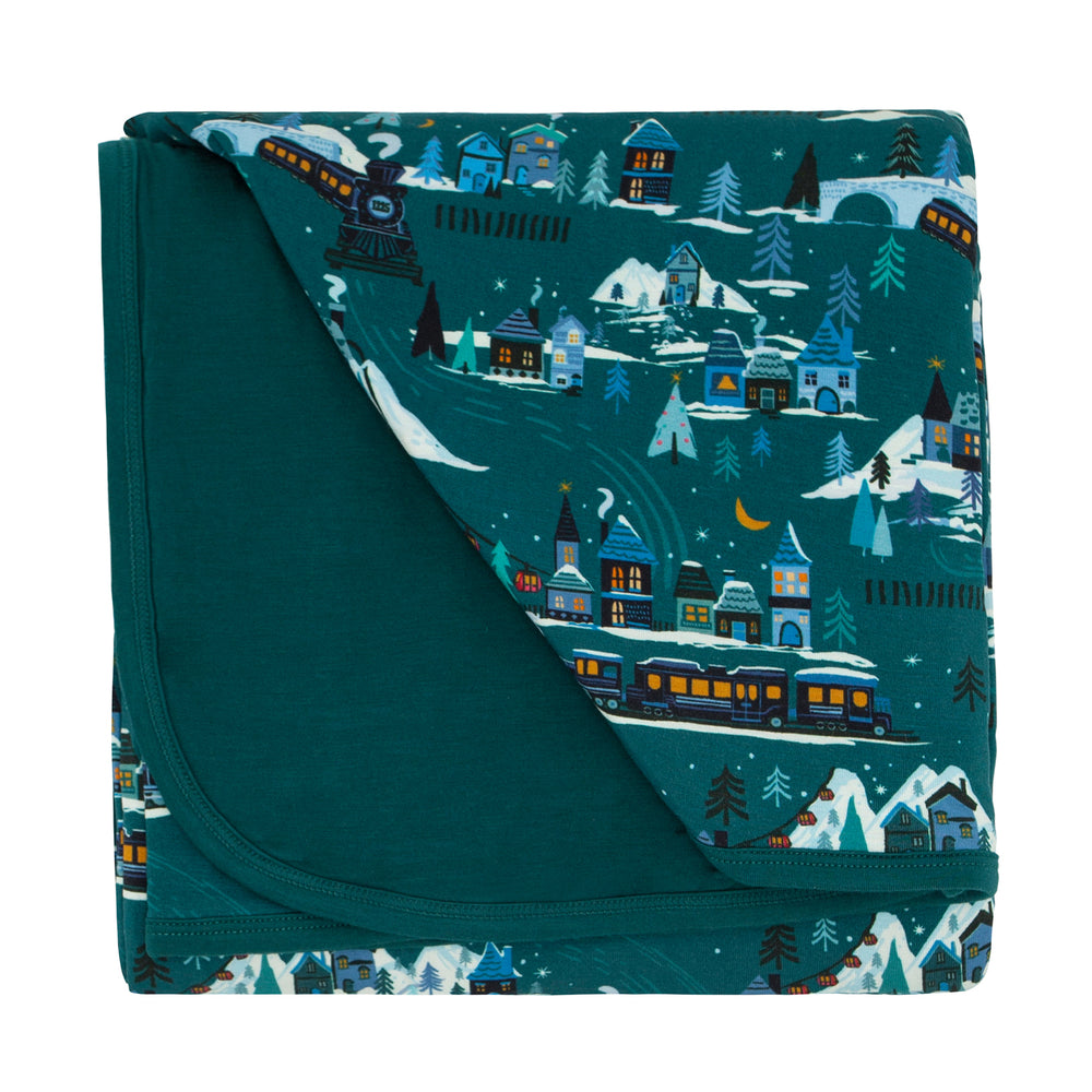Flat lay image of Midnight express cloud blanket showing the solid teal backing