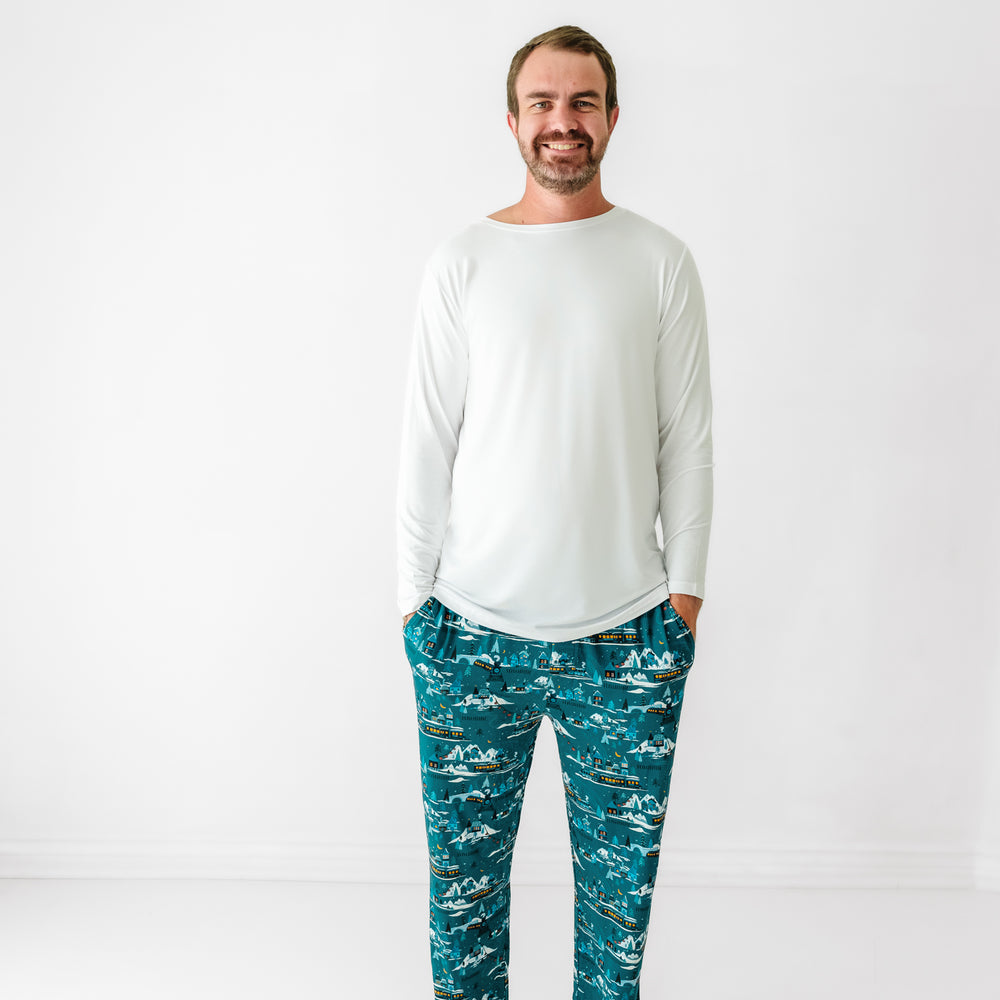 Man wearing a men's Bright White pajama top paired with men's Midnight Express pajama pants