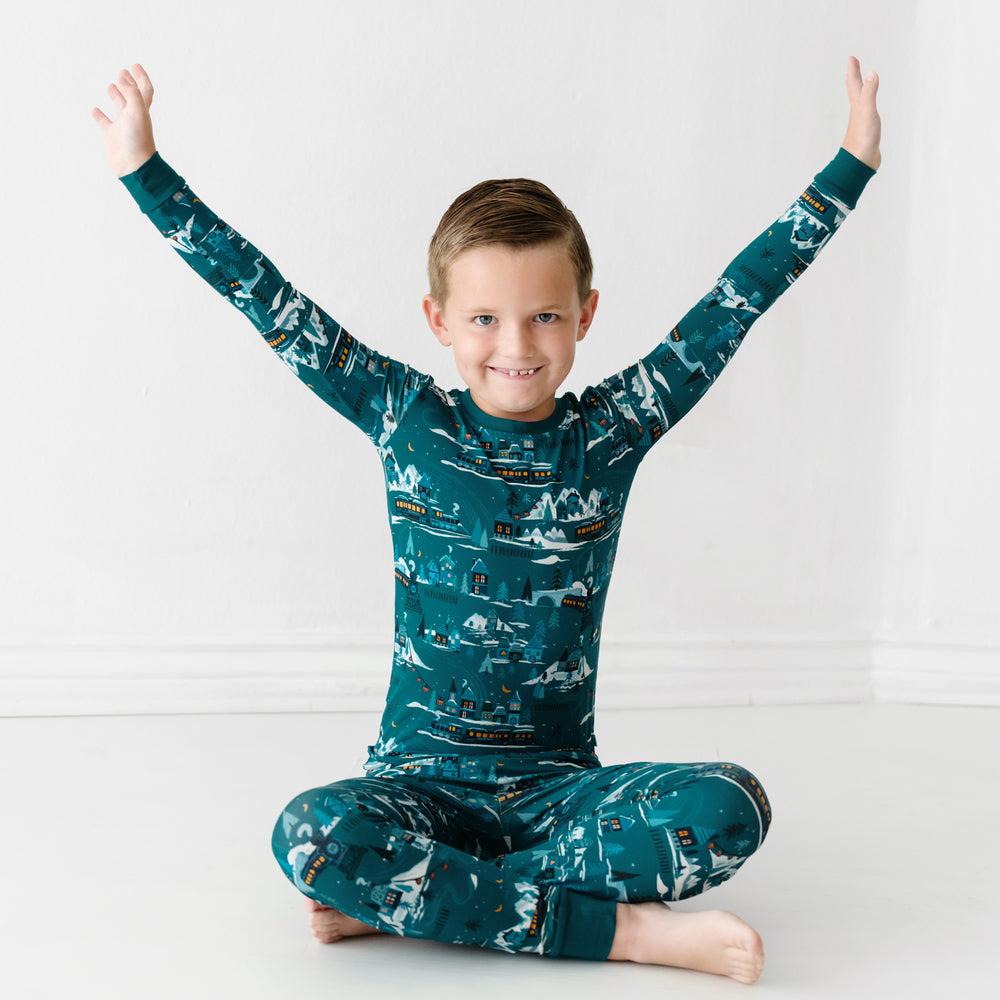 Child sitting wearing a Midnight Express two piece pajama set