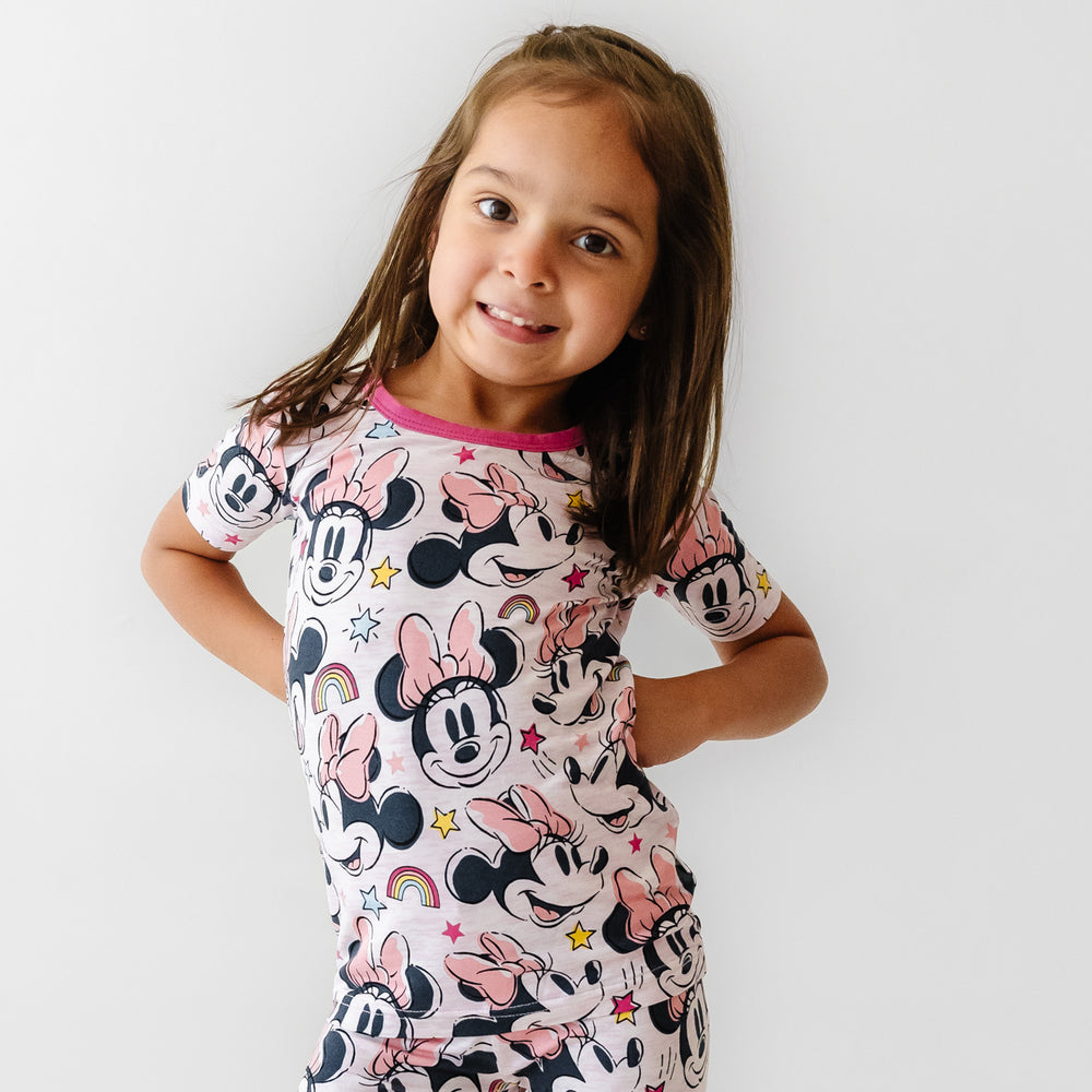 Close up image of a child wearing a Minnie Forever printed two piece short sleeve pajama set