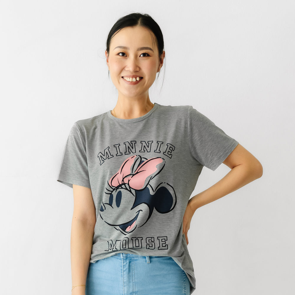 Woman with her hand on her hip wearing a Minnie collegiate women's graphic tee