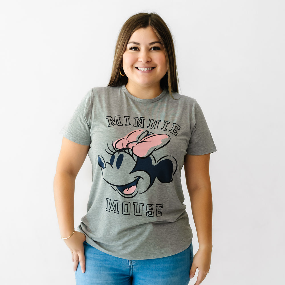 Woman with her hand in her pocket wearing a Mickey collegiate women's graphic tee