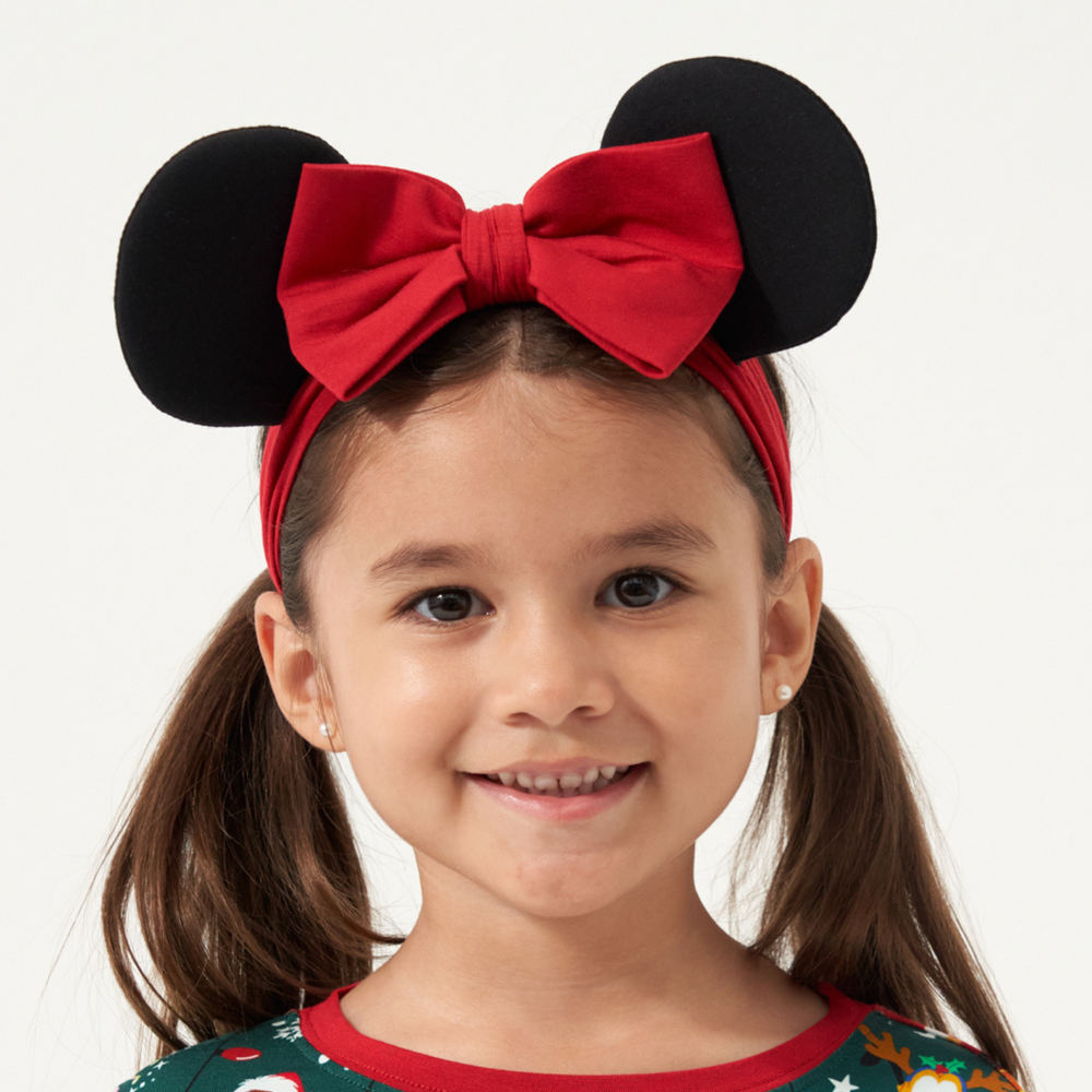 close up image of a child wearing a minnie mouse luxe bow headband