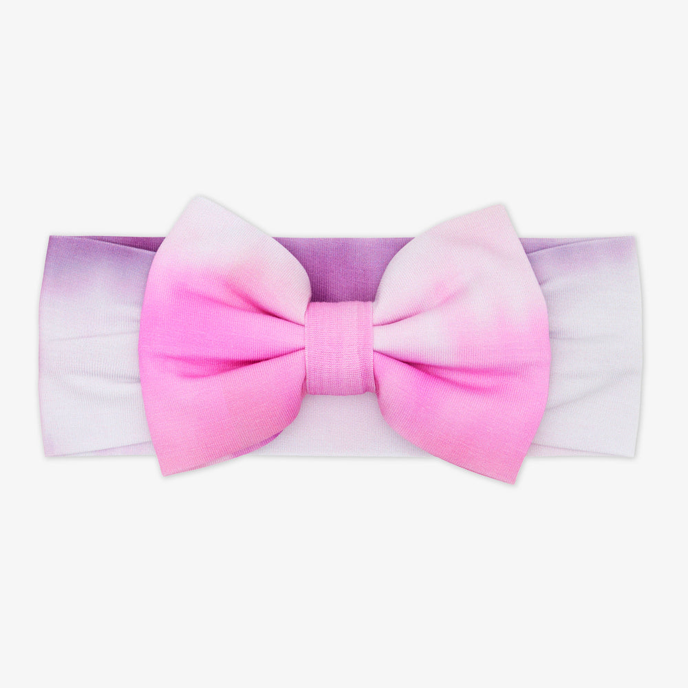 Flat lay of the Pink Cosmic Mist Luxe Bow Headband