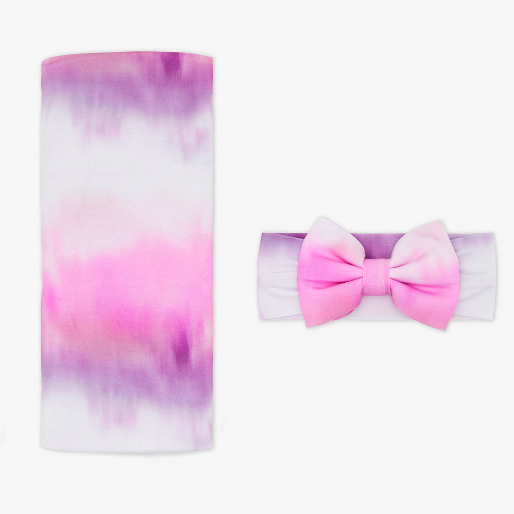 Flat lay of the Pink Cosmic Mist Swaddle & Luxe Bow Headband Set