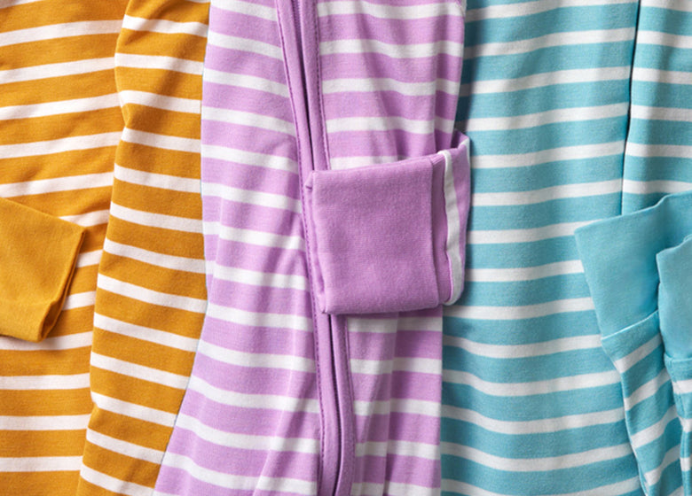 Flat lay of yellow, purple and blue striped pajamas