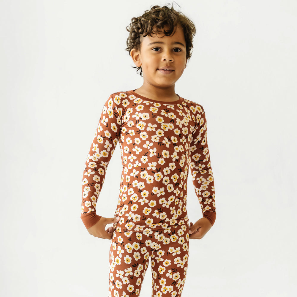 Close up image of a child wearing a Mocha Blossom printed long sleeve pajama set