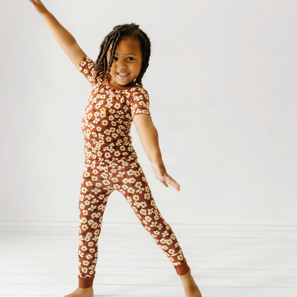 Child dancing wearing a Mocha Blossom printed short sleeve pajama set