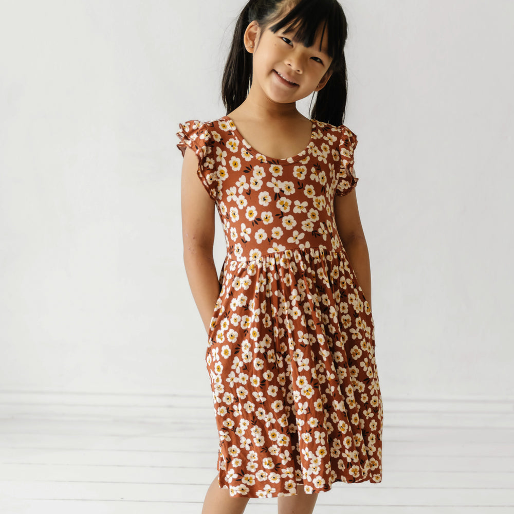 Child wearing a Mocha Blossom printed twirl dress