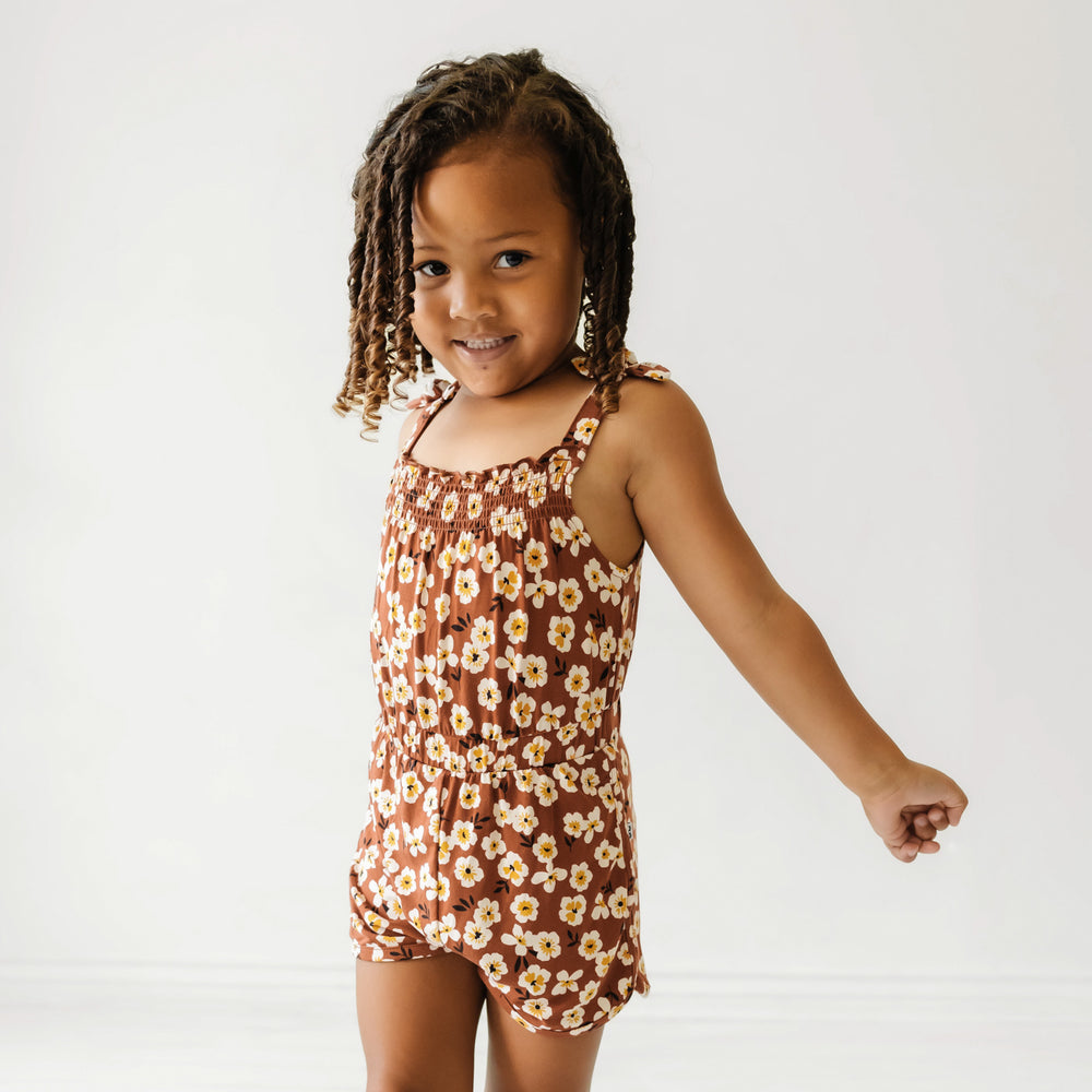 Child wearing a Mocha Blossom printed smocked romper