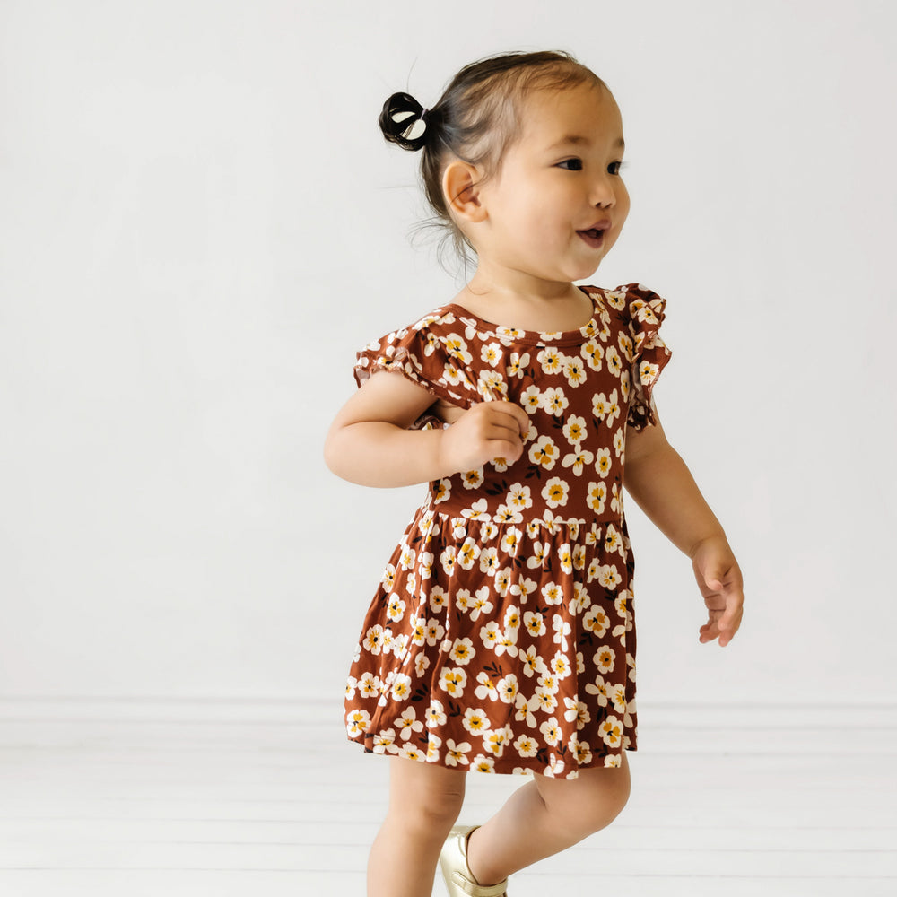 Child running wearing a Mocha Blossom printed twirl dress with bodysuit