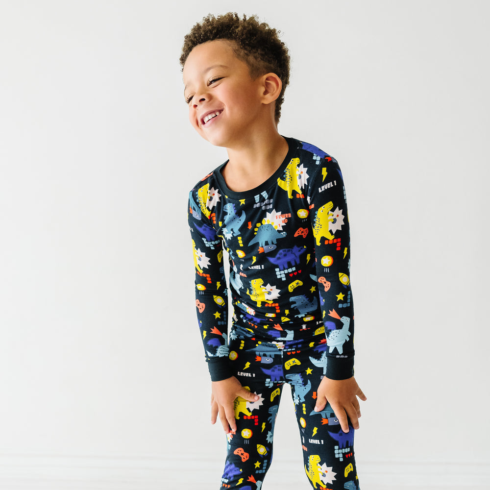 Close up image of a child wearing Next Level Dinos two piece pajama set