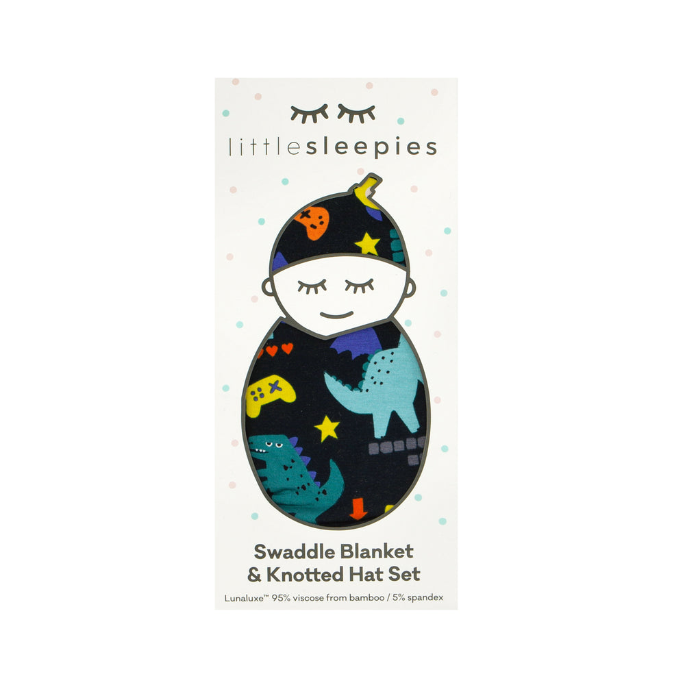 Image of a Next Level Dinos swaddle and hat set in Little Sleepies peek a boo packaging