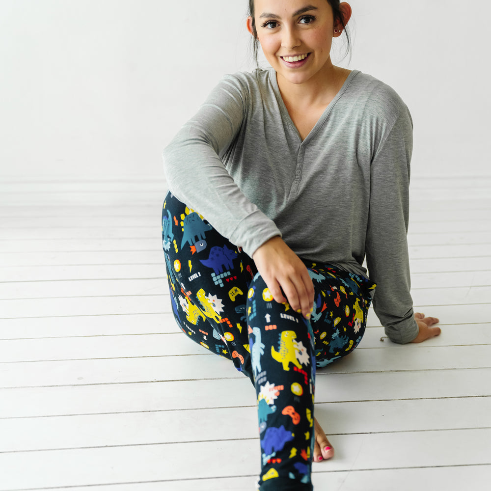 Alternate image of a woman posing wearing women's Next Level Dinos pajama pants paired with a coordinating women's Heather Gray pajama top
