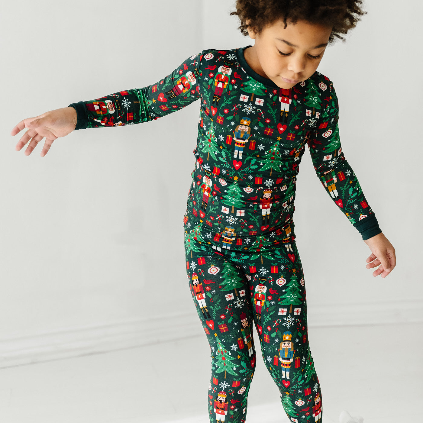 Close up image of a child wearing a Night at the Nutcracker two piece pajama set