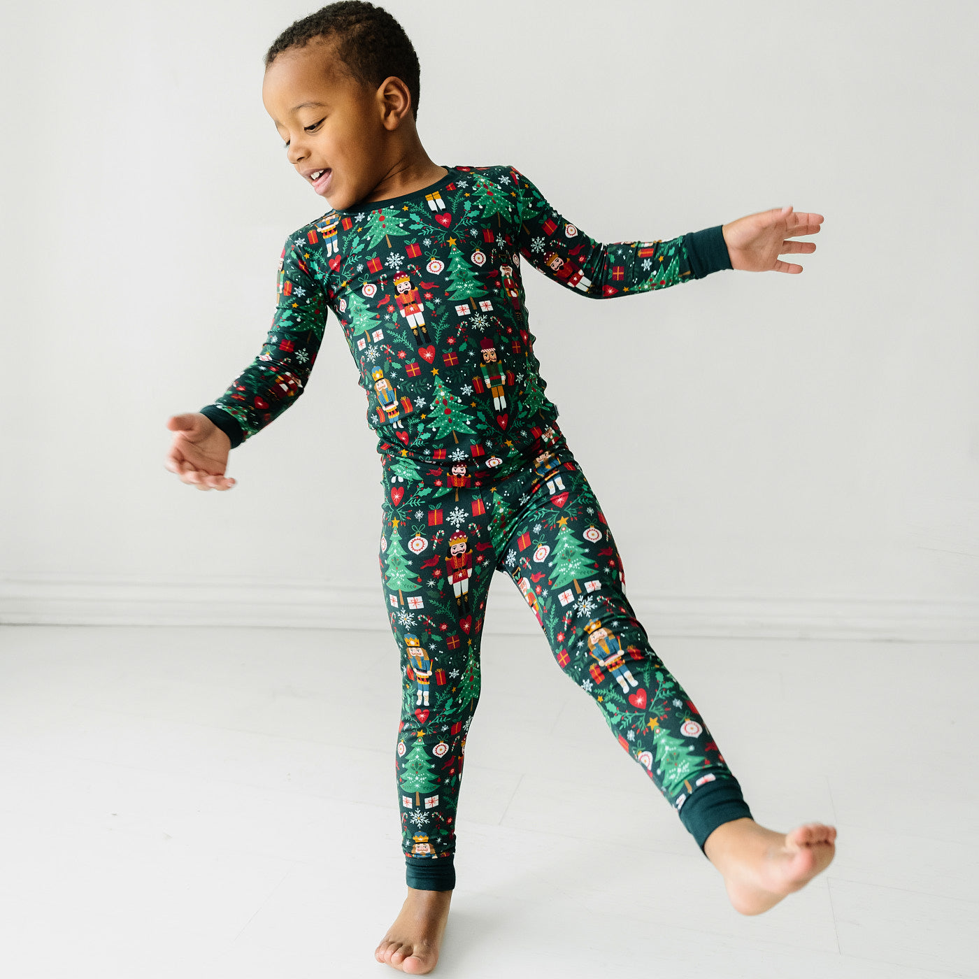 child posing wearing a Night at the Nutcracker two piece pajama set