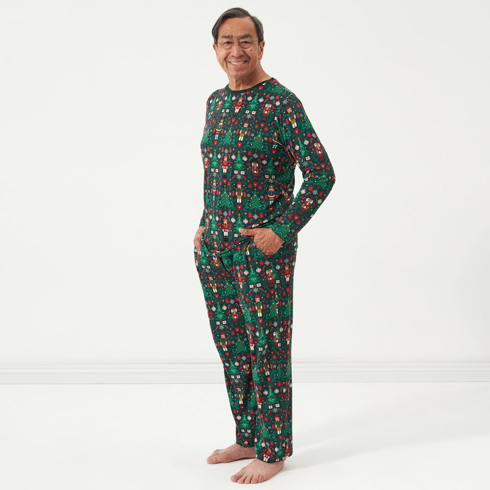 Man wearing men's Night at the Nutcracker pajama top and matching pajama bottoms.