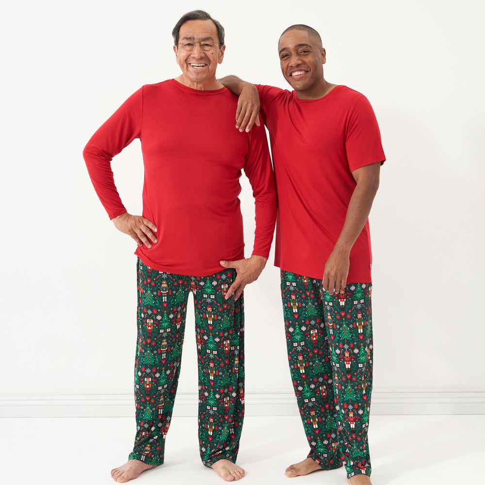 Two men posting together wearing men's Night at the Nutcracker printed pajama bottoms paired with a Holiday Red men's pajama tops in short and long sleeve styles