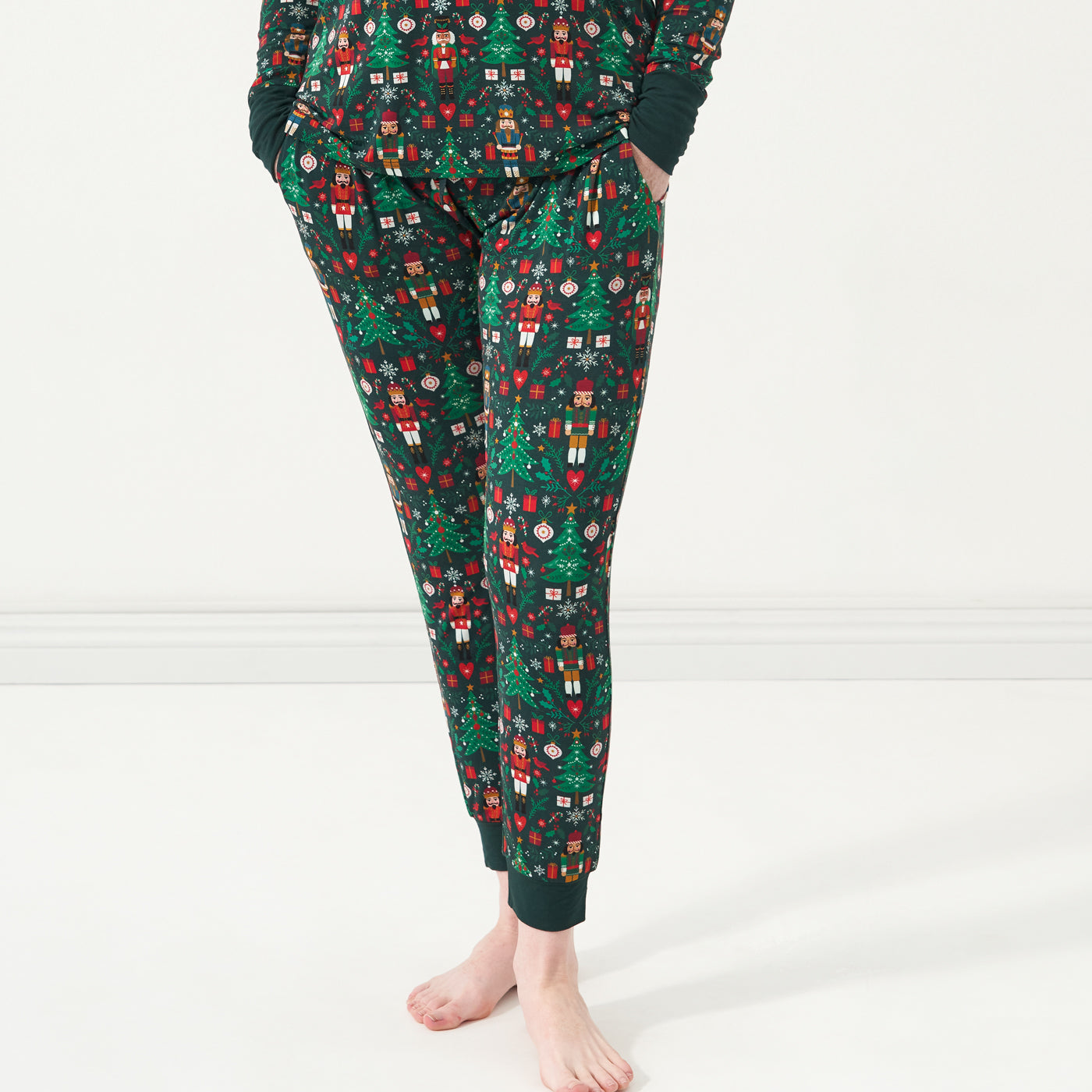 Close up image of a woman wearing Night at the Nutcracker women's pajama bottoms