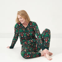 Woman sitting and posing wearing Night at the Nutcracker women's pajama top and women's pajama bottoms
