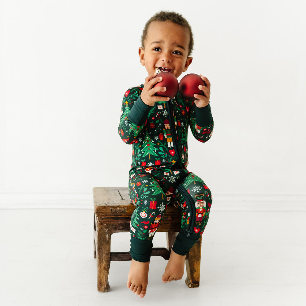 Child sitting on a stool playing while wearing Night at the Nutcracker zippy