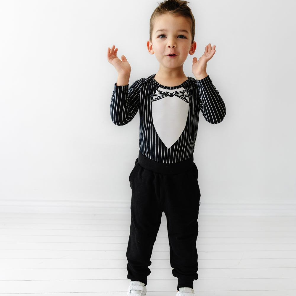 Child wearing a Jack Skellington graphic bodysuit and coordinating black joggers