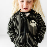Close up image of a child wearing a Jack Skellington Zip Hoodie with the zipper all the way up