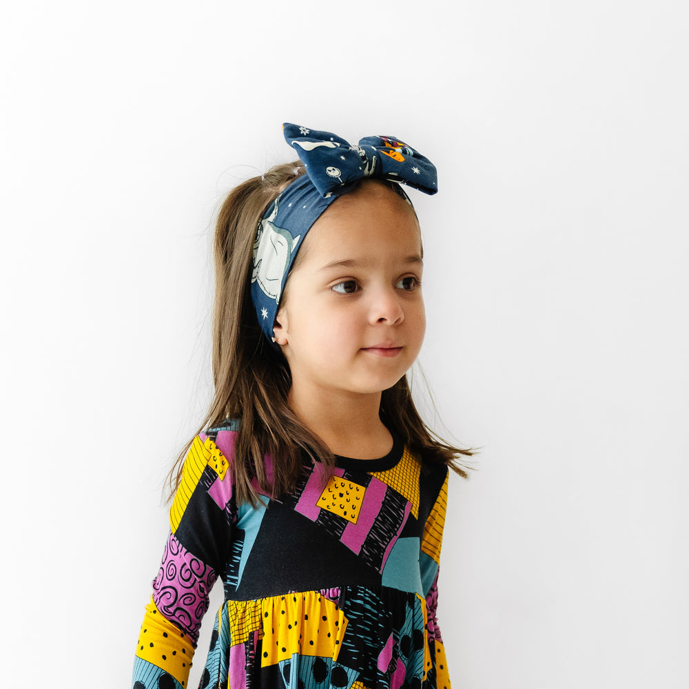 Alternate image of a child wearing a Jack Skellington and Friends printed luxe bow headband