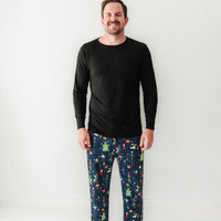 Man wearing Jack Skellington and Friends printed men's pajama pants and coordinating black men's pajama top