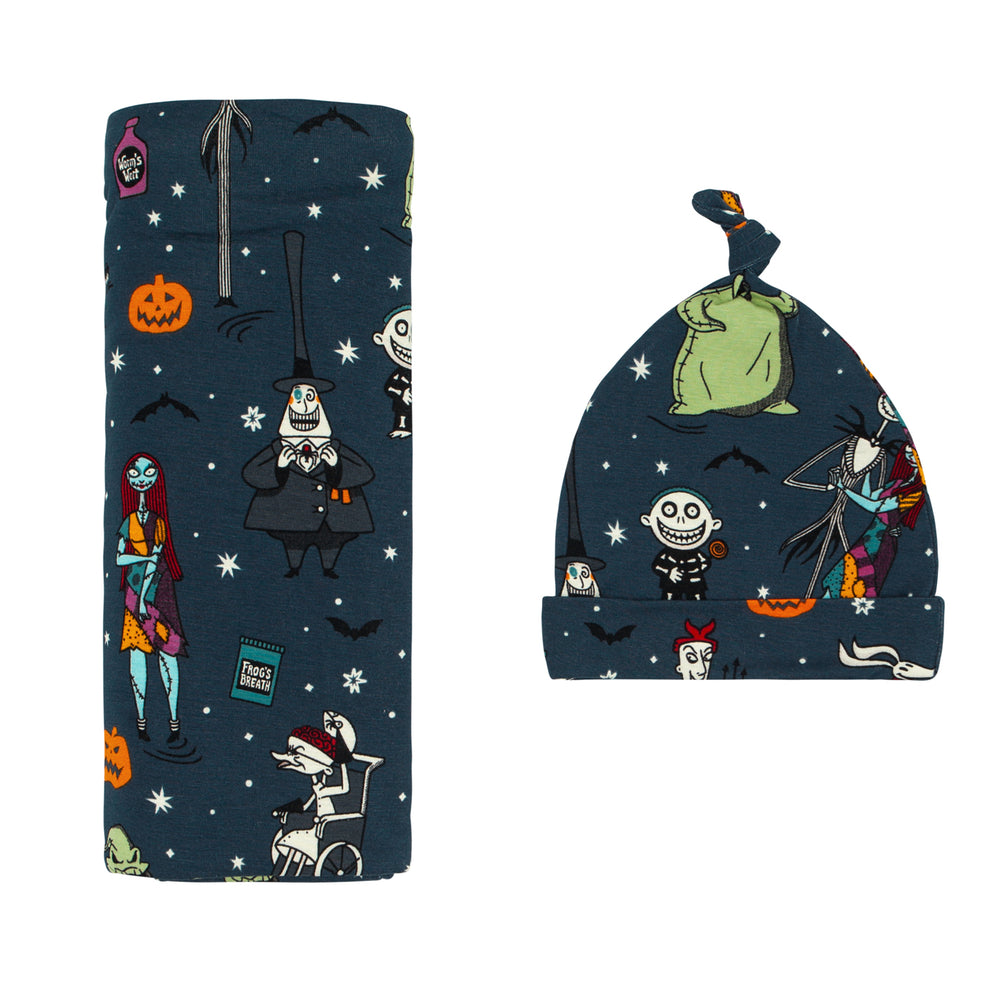 Flat lay image of a Jack Skellington and Friends swaddle and hat set