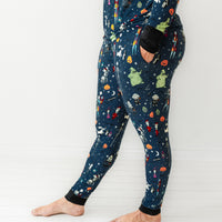 Side view image of a woman wearing Jack Skellington and Friends printed women's pajama pants