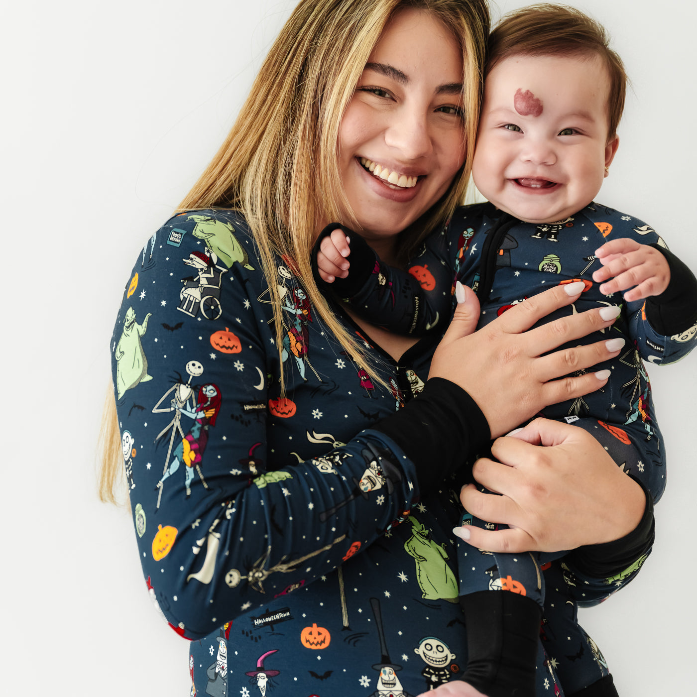 Woman and child wearing matching Jack Skellington and Friends printed pajamas