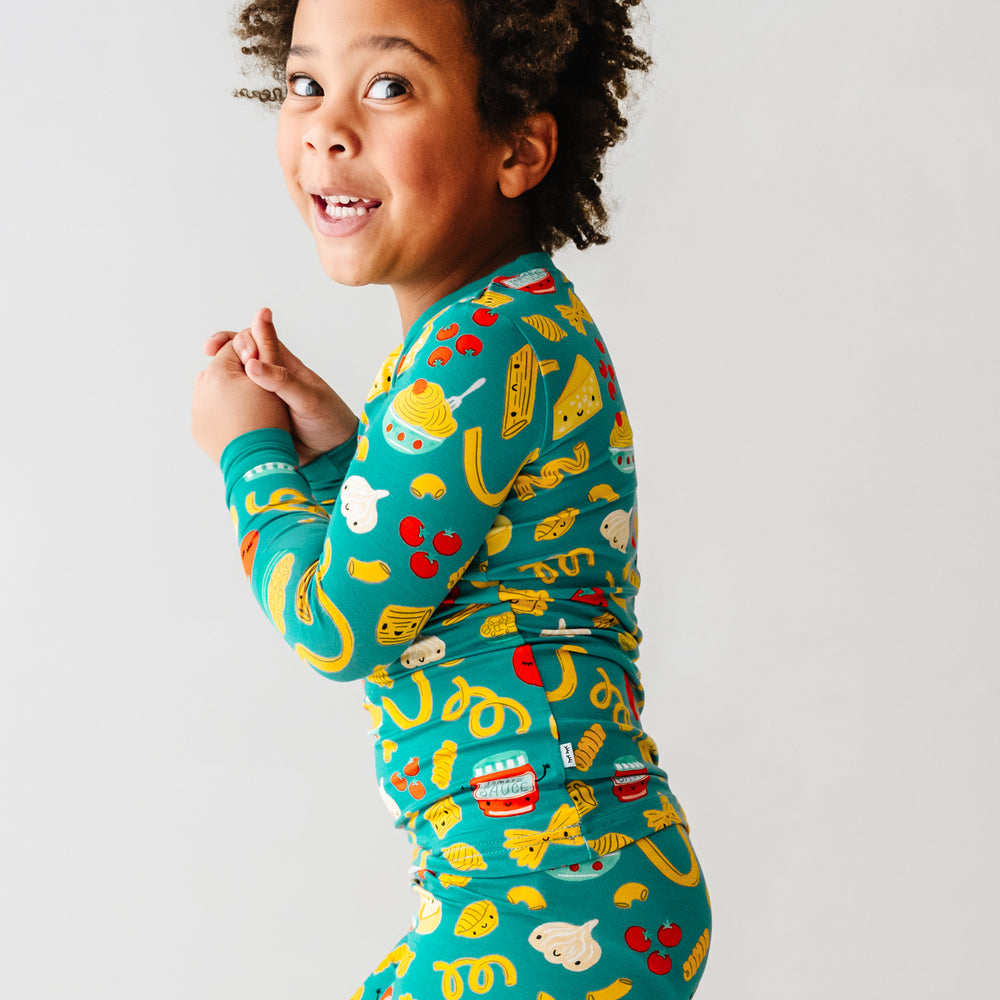 Click to see full screen - Side view image of a child wearing a Pasta Party two-piece pajama set
